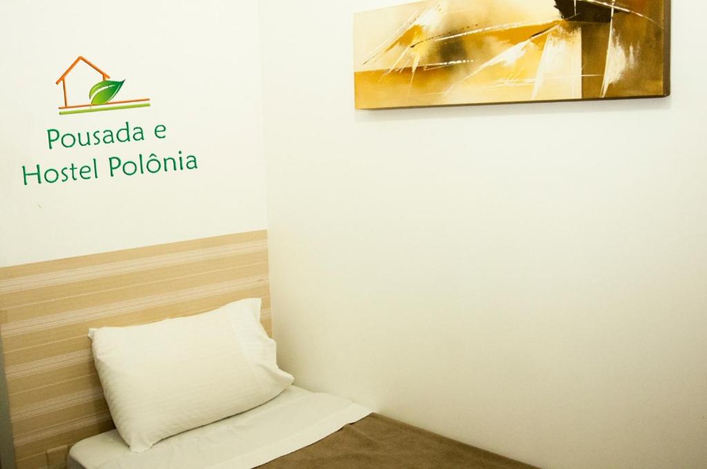 a room with a pillow and a picture on the wall at Pousada Polônia in Porto Alegre