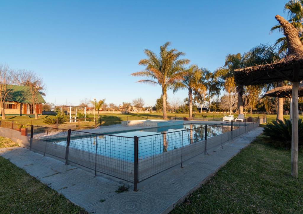 a swimming pool with a fence around it at Complejo Paradise in Colón