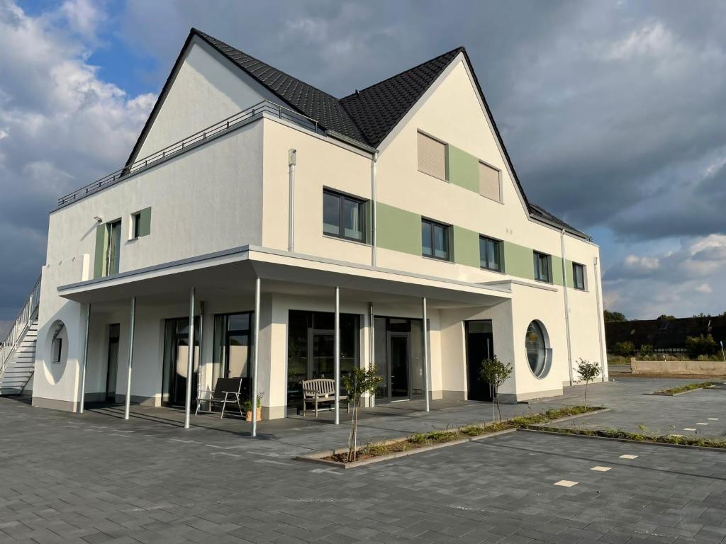 a large white building with a black roof at Gästehaus Vondey in Salzkotten