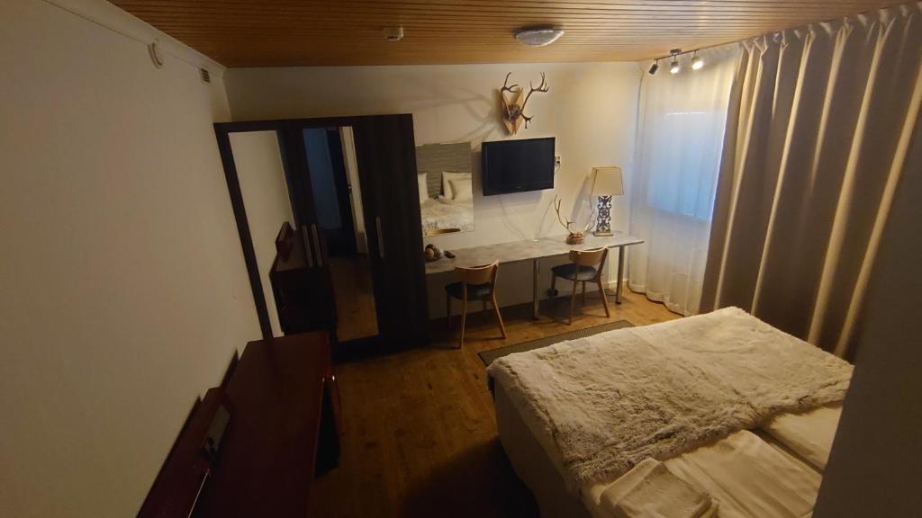 TV a/nebo společenská místnost v ubytování Hotel Guossi