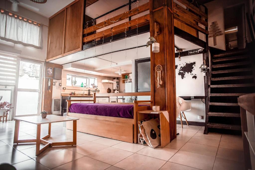 a bedroom with a bunk bed with purple sheets at Departamento SUR in Ushuaia