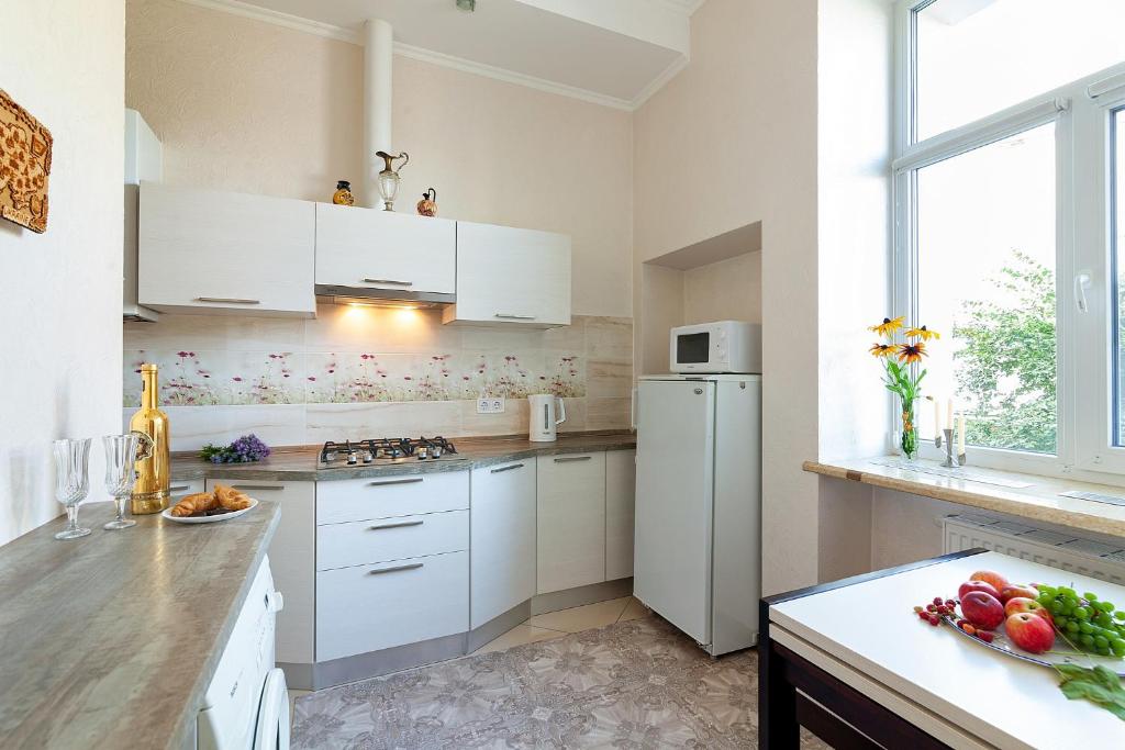 a kitchen with white cabinets and a white refrigerator at Apartment 3, room 4, Tamanska, Дарії Гусяк in Lviv