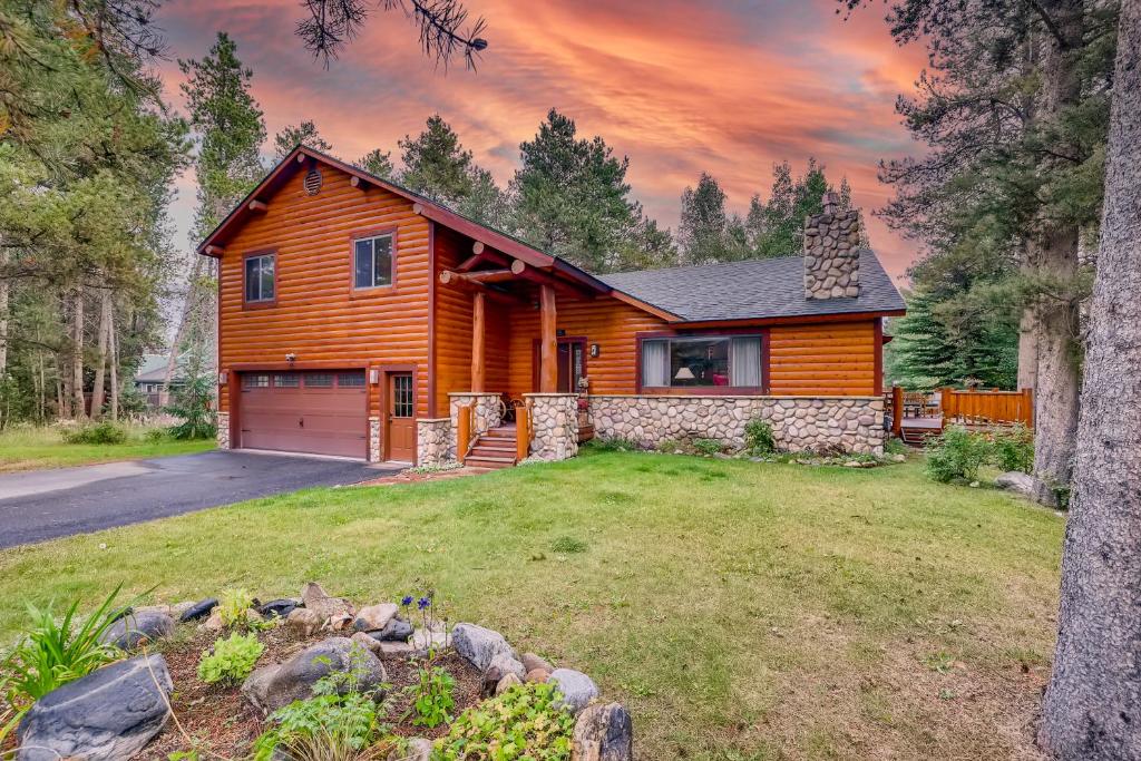 a wooden house with a garage in a yard at Casa de Montagne Home: High-End Log Home, Downtown Frisco in Frisco