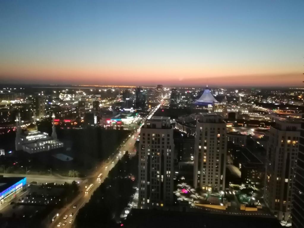 a view of a city lit up at night at Apart Hotel 36 этаж in Astana