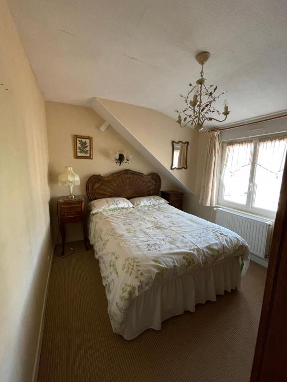 a bedroom with a large bed in a attic at Le Grand Chalet in Bagnoles de l&#39;Orne