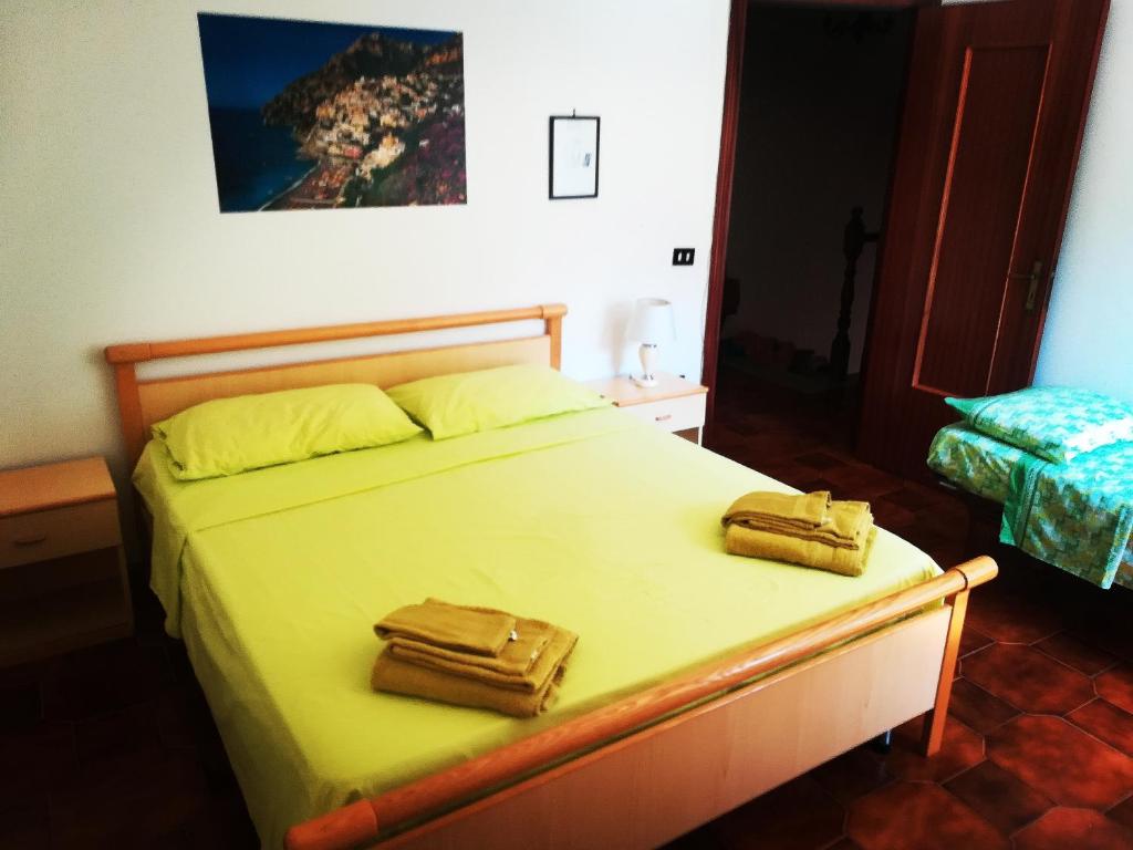 a bedroom with a bed with two towels on it at Casa Giordano Holidays in Tramonti