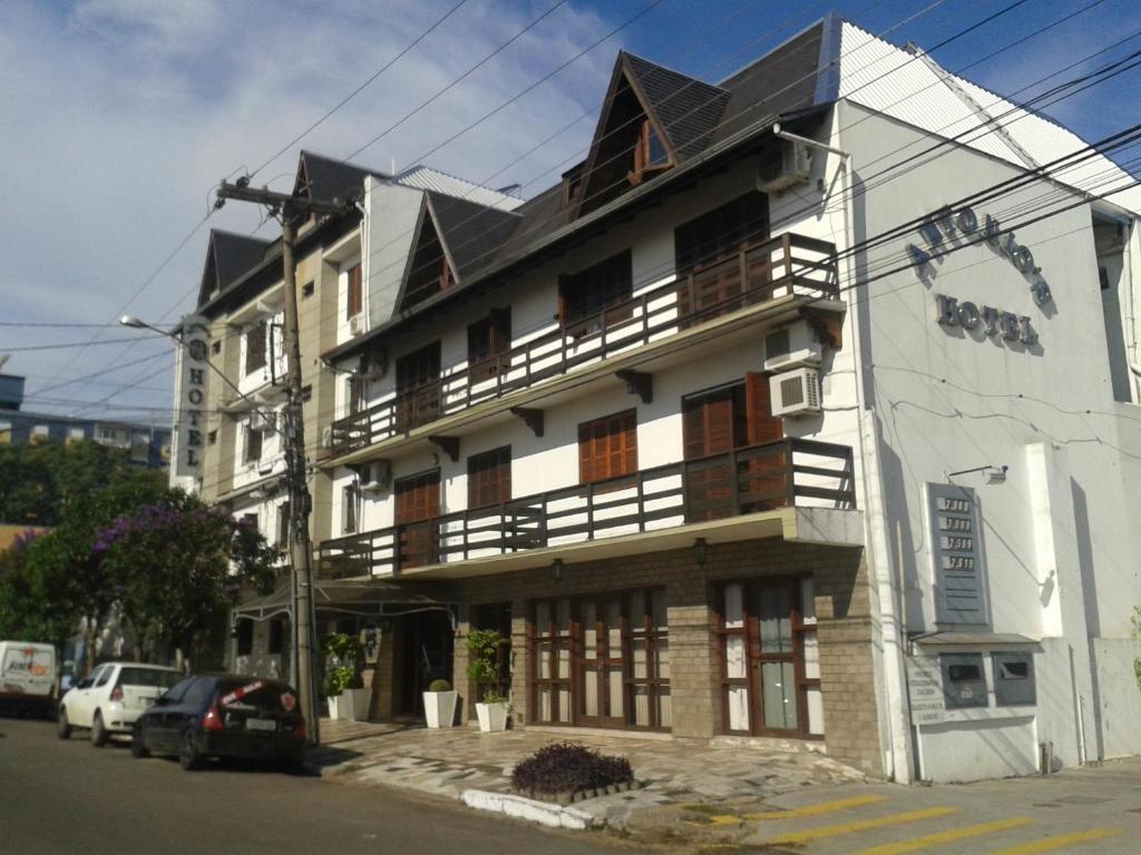 a building with a balcony on the side of it at Hotel Antonio's in Santa Cruz do Sul