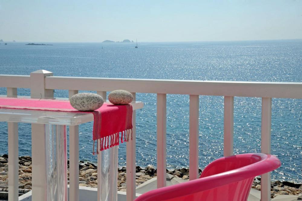 dos ositos de peluche sentados en una mesa con vistas al océano en Villa Kastro, en Parikia