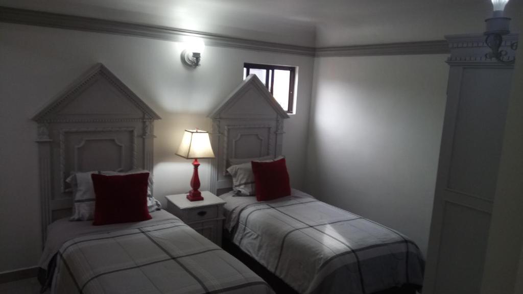 Postel nebo postele na pokoji v ubytování Hotel Hacienda los Narcisos