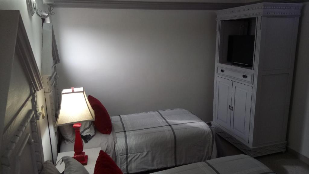 Postel nebo postele na pokoji v ubytování Hotel Hacienda los Narcisos