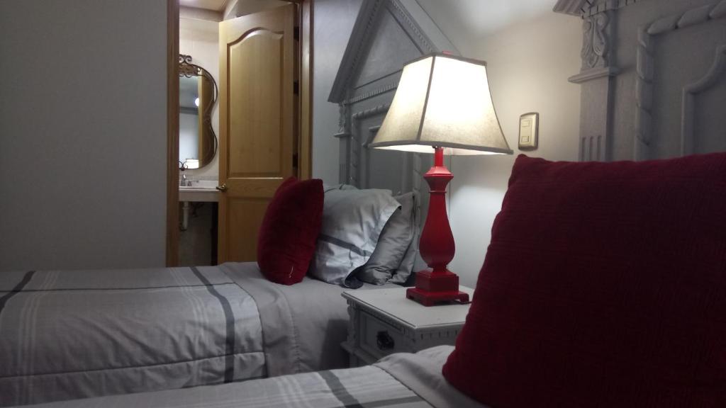 Postel nebo postele na pokoji v ubytování Hotel Hacienda los Narcisos