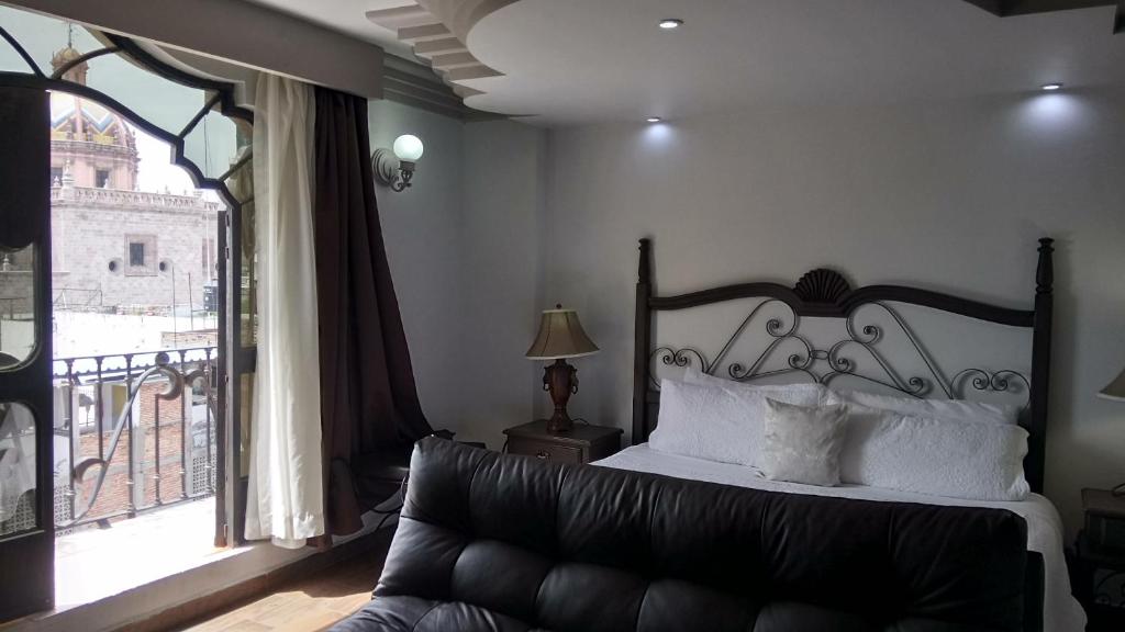 Postel nebo postele na pokoji v ubytování Hotel Hacienda los Narcisos