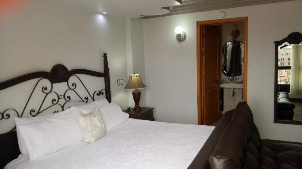 Postel nebo postele na pokoji v ubytování Hotel Hacienda los Narcisos