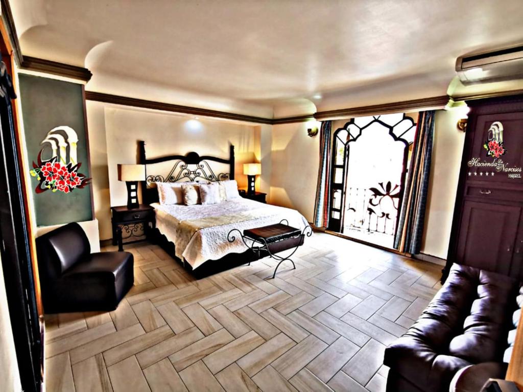 Postel nebo postele na pokoji v ubytování Hotel Hacienda los Narcisos