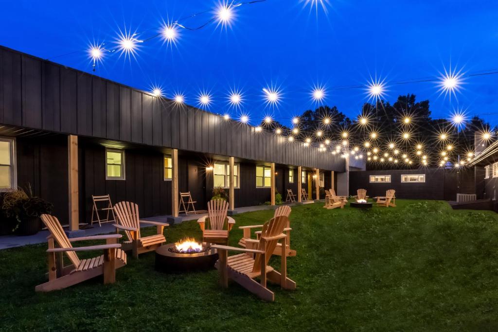 a patio with chairs and a fire pit at night at The Alander in Copake