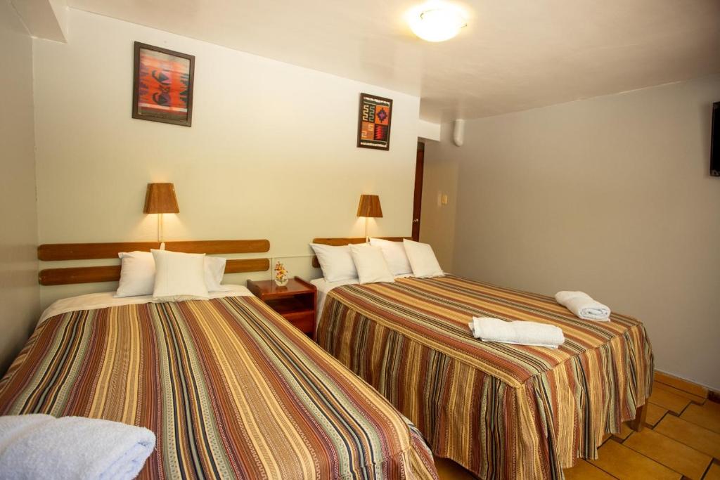 Postel nebo postele na pokoji v ubytování Hostal La Payacha MachuPicchu