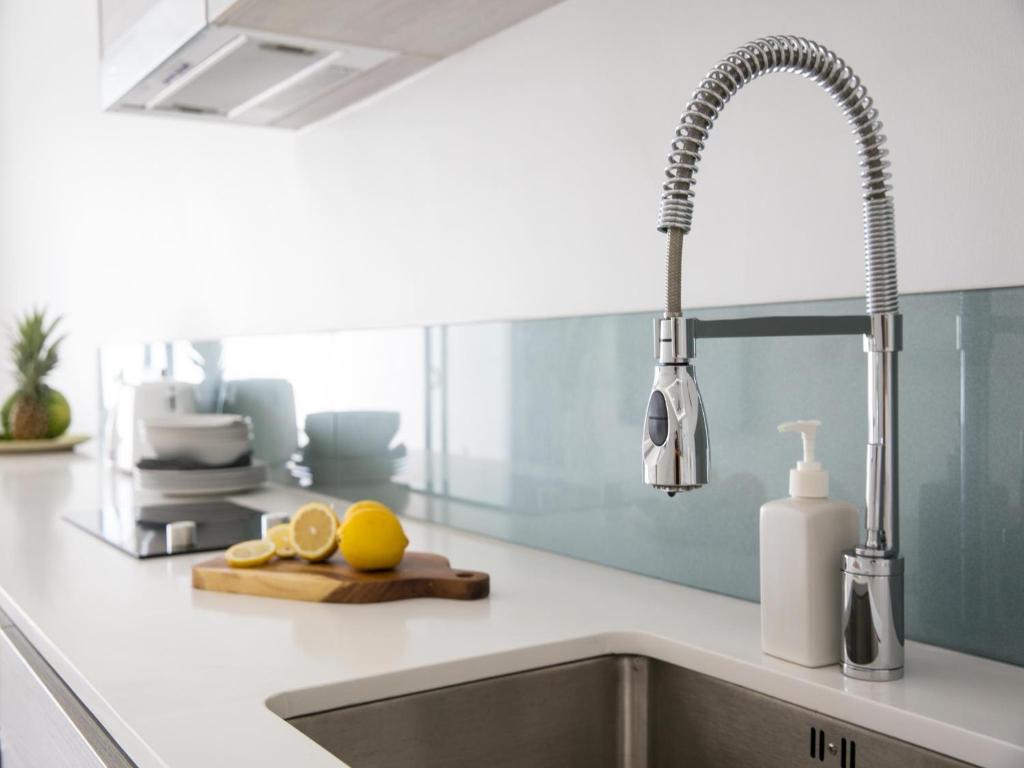 a kitchen counter with a sink and a faucet at Skye Beach Hotel - Koh Samui in Choeng Mon Beach