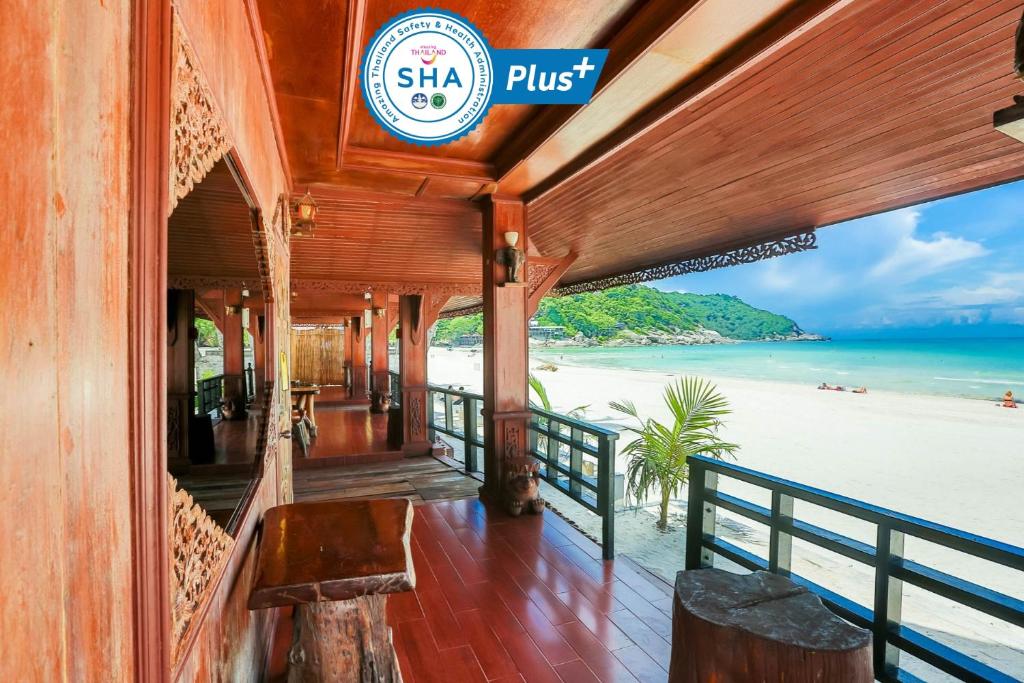 a restaurant with a view of the beach at Sunrise Resort- Koh Phangan - SHA Extra Plus in Haad Rin