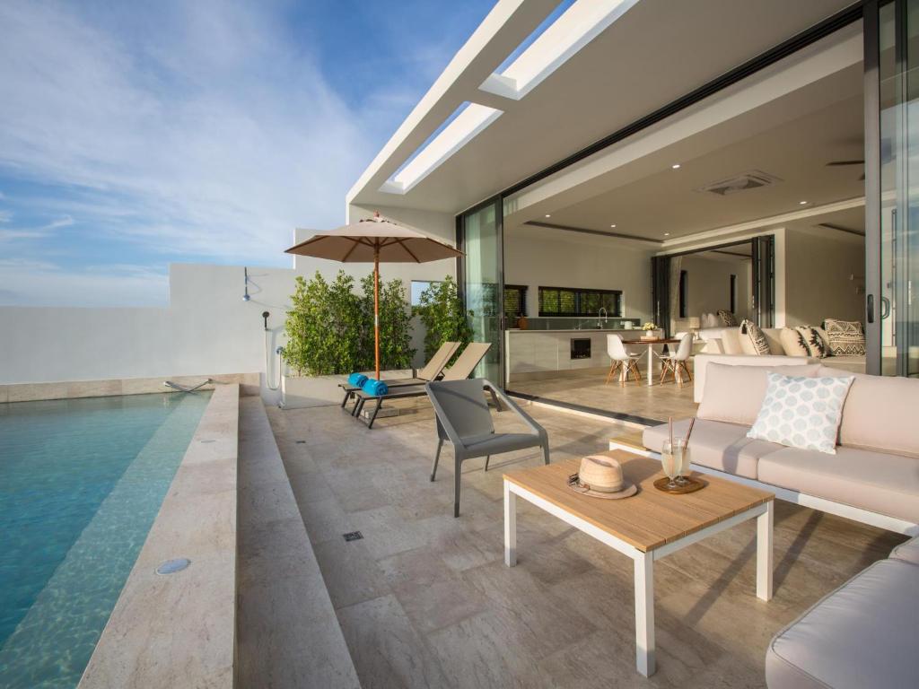 an open living room with a pool and a villa at Skye Beach Hotel - Koh Samui in Choeng Mon Beach