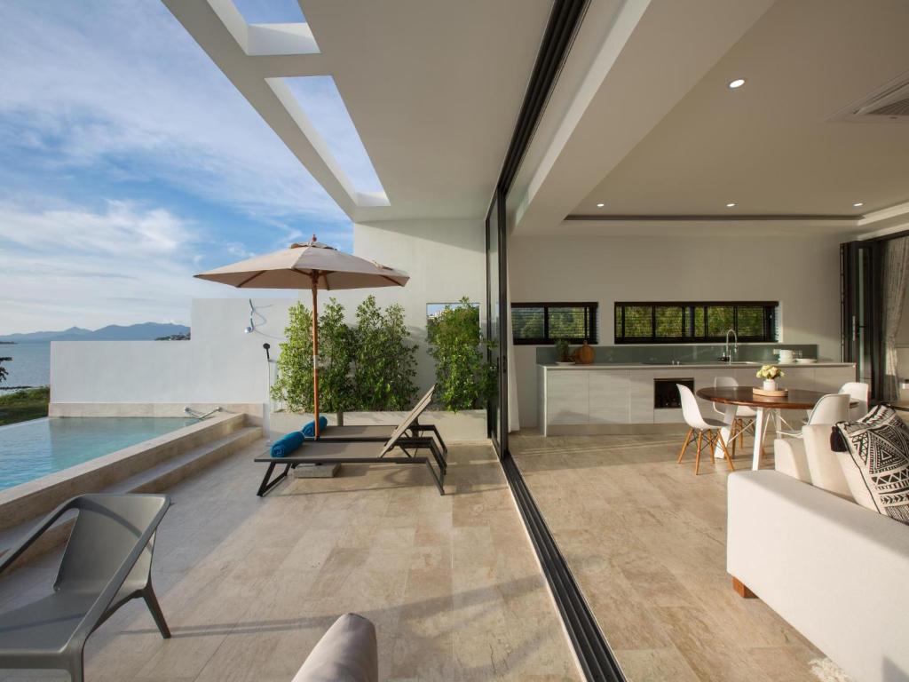an open living room with a view of the ocean at Skye Beach Hotel - Koh Samui in Choeng Mon Beach