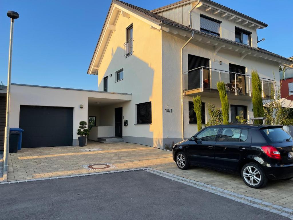 a black car parked in front of a house at Harmonie am Bodensee in Friedrichshafen