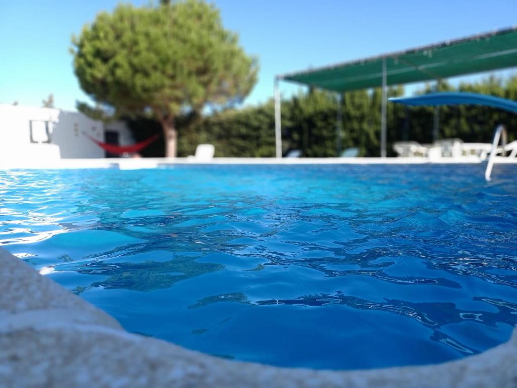 a swimming pool with blue water in a resort at SOLECITO in Chiclana de la Frontera