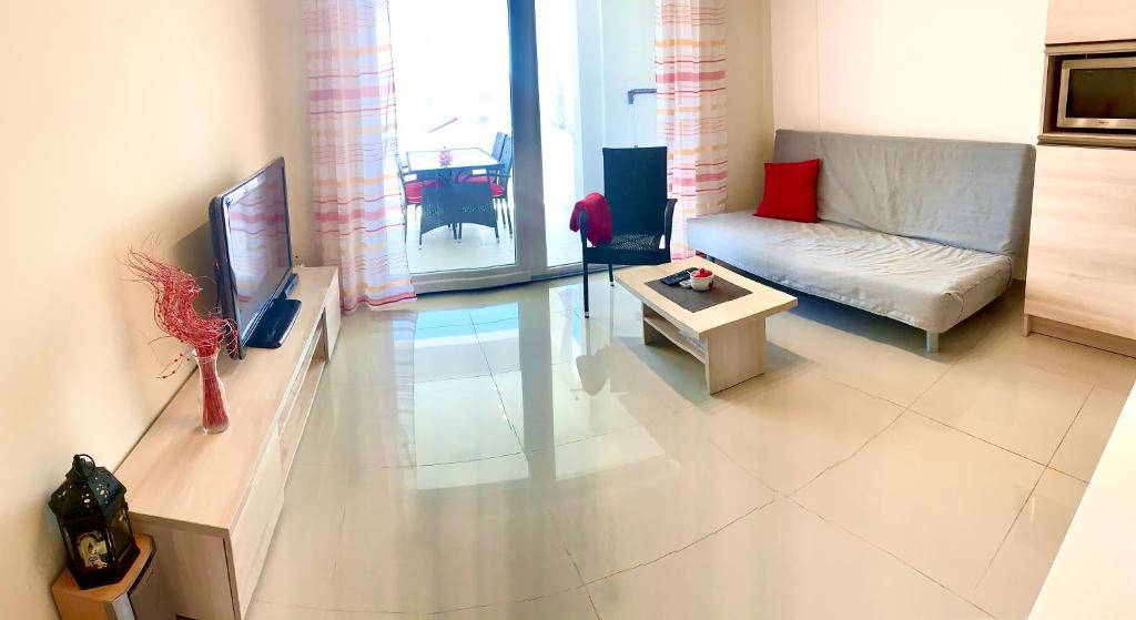 a living room with a couch and a table at Apartment Lucie 4 in Biograd na Moru