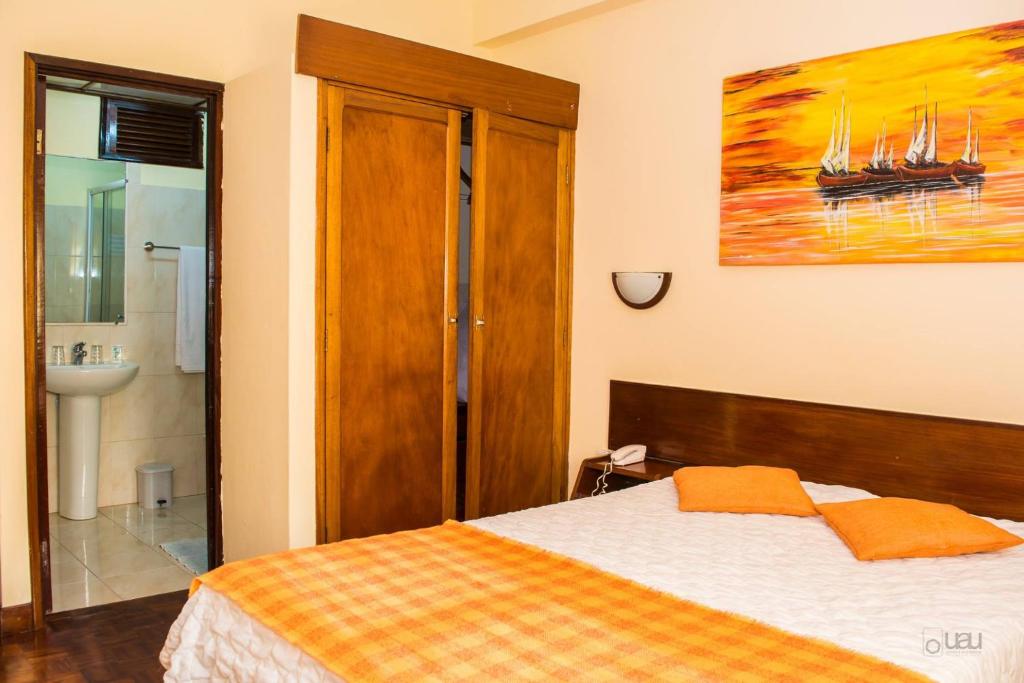 Postel nebo postele na pokoji v ubytování Aparthotel Avenida