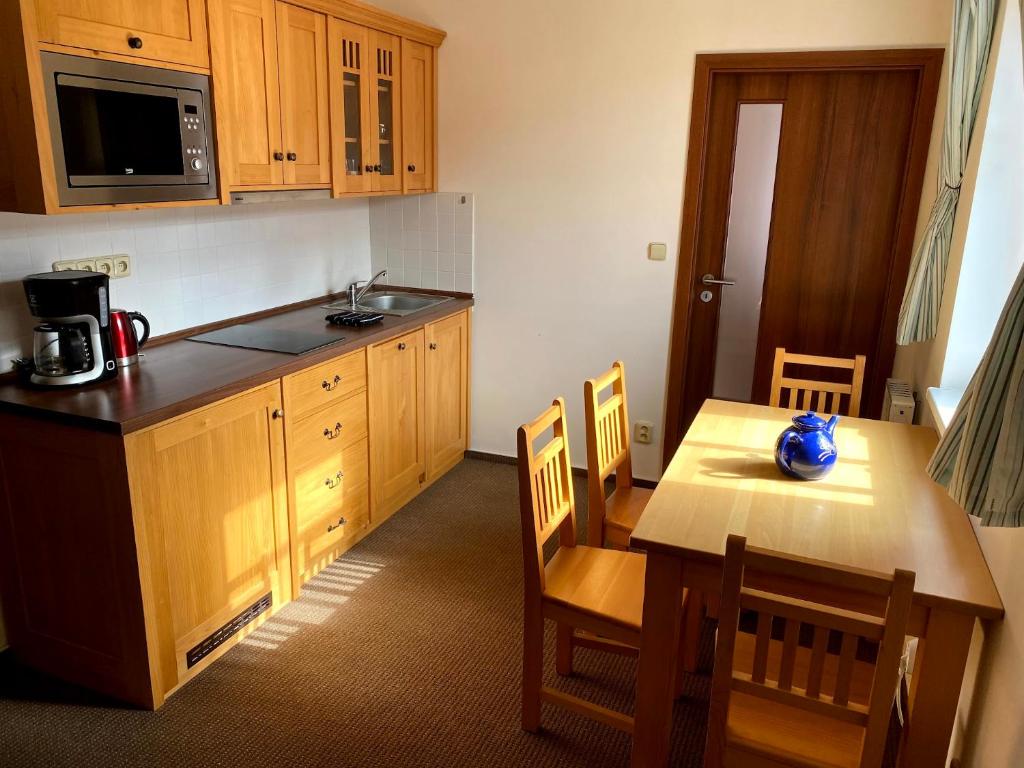 a kitchen with a wooden table and a table and chairs at Byt Malá Úpa in Horní Malá Úpa