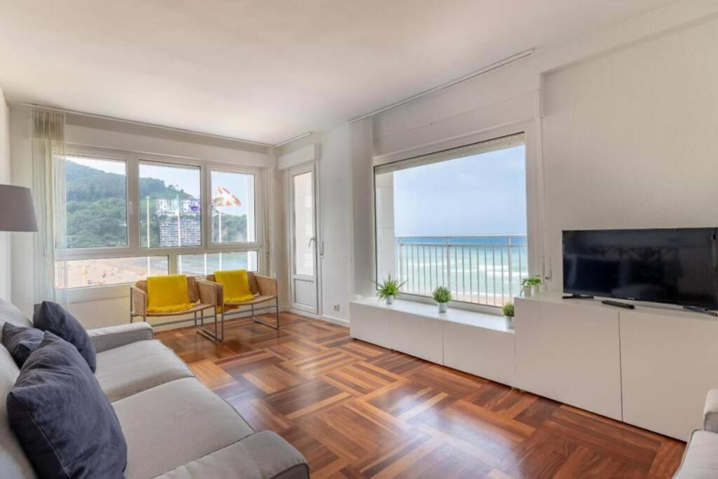 a living room with a couch and a flat screen tv at Bakio Beach in Bakio