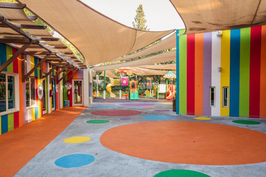 an empty arcade with a playground with colorful walls at Sherwood Exclusive Kemer - Kids Concept in Kemer