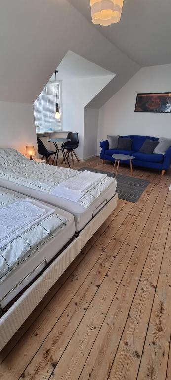 sypialnia z dużym łóżkiem i drewnianą podłogą w obiekcie Korsør Room w mieście Korsør
