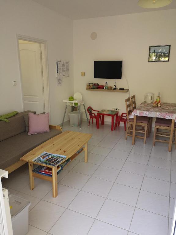 a living room with a couch and a table at Atlantika Apartman in Balatonboglár