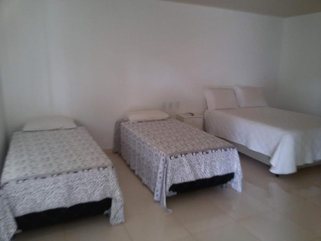 a room with two beds and a couch at Pouso da Soraya in Rio de Contas