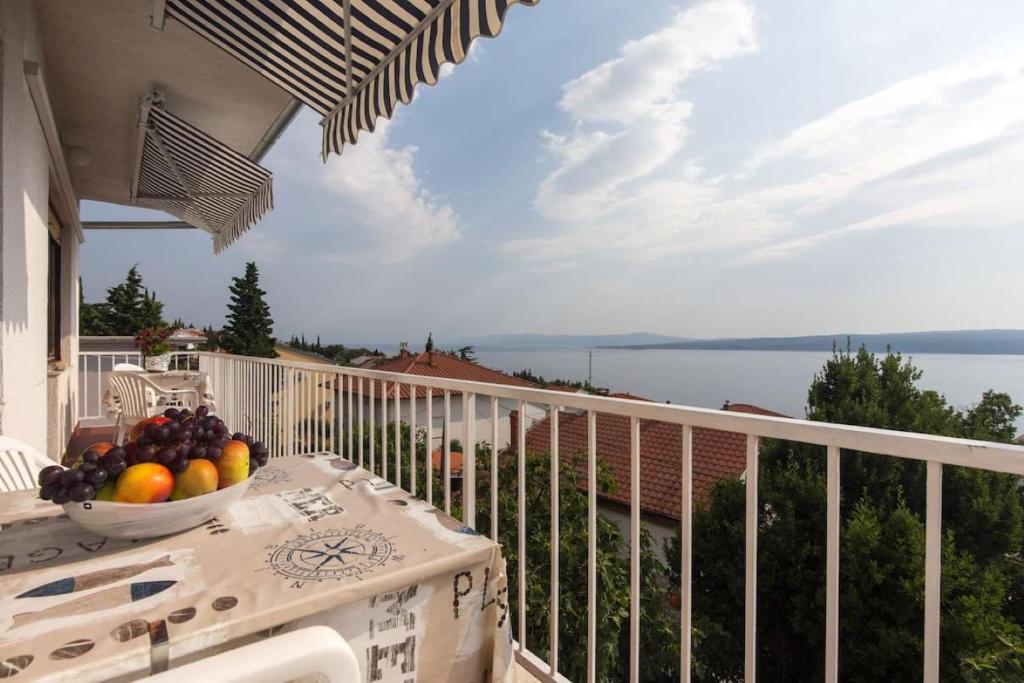a bowl of fruit on a table on a balcony at Apartments Simona in Crikvenica