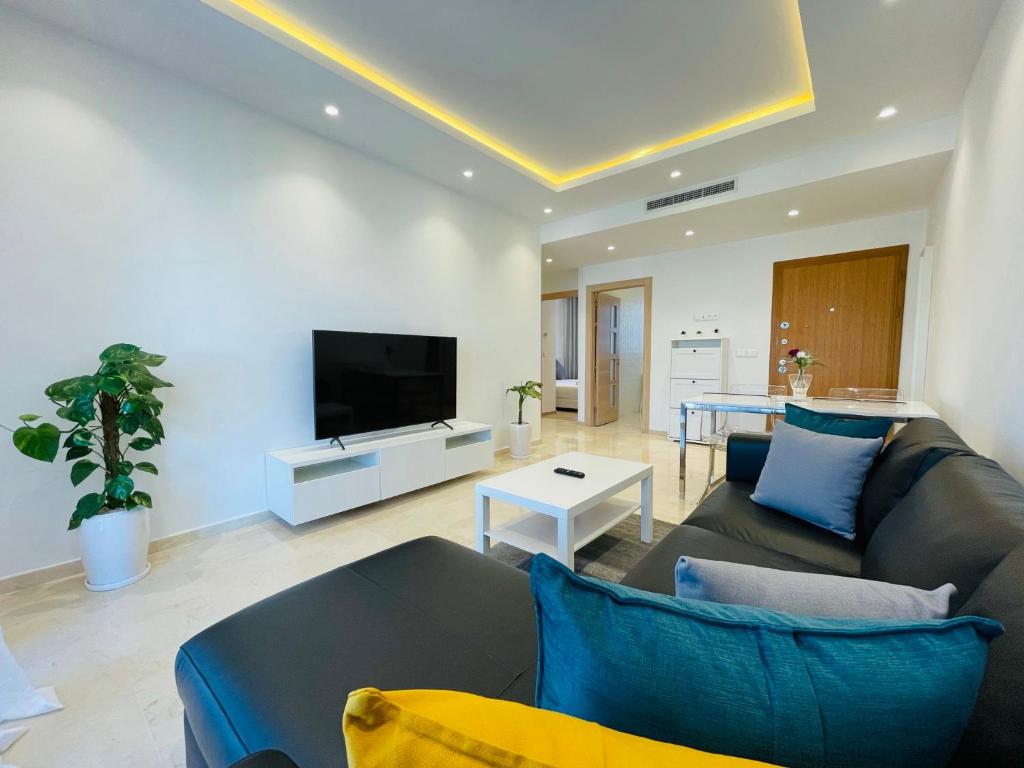 a living room with a couch and a tv at Zen Apartment in the center of Tangier in Tangier