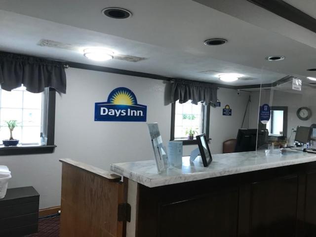 a kitchen with a counter top and a large window at Days Inn by Wyndham Amherst in Amherst
