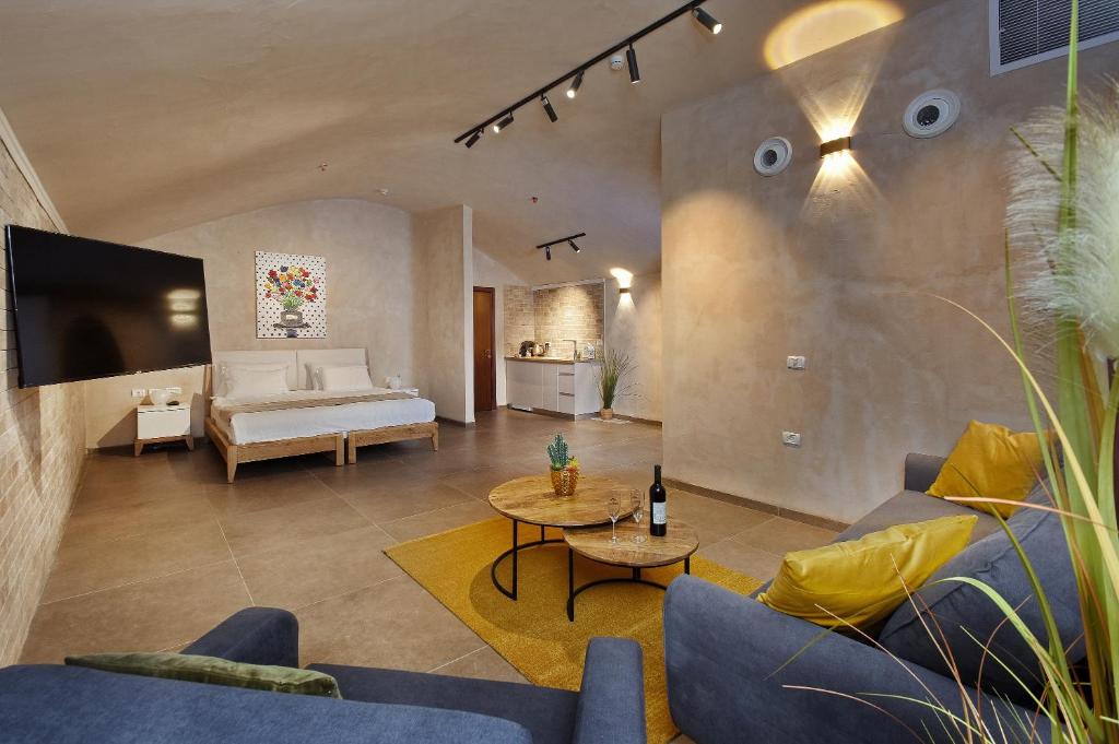 a living room with a couch and a table at Romano Hotel Boutique in Safed