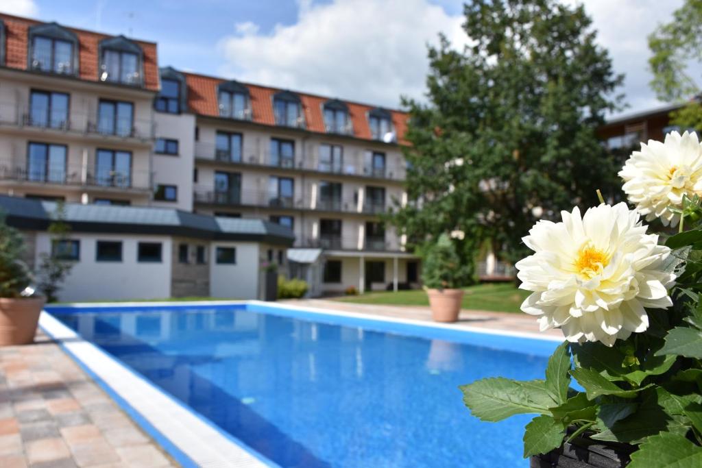 a swimming pool in front of a building at Aqualux Wellness- & Tagungshotel in Bad Salzschlirf