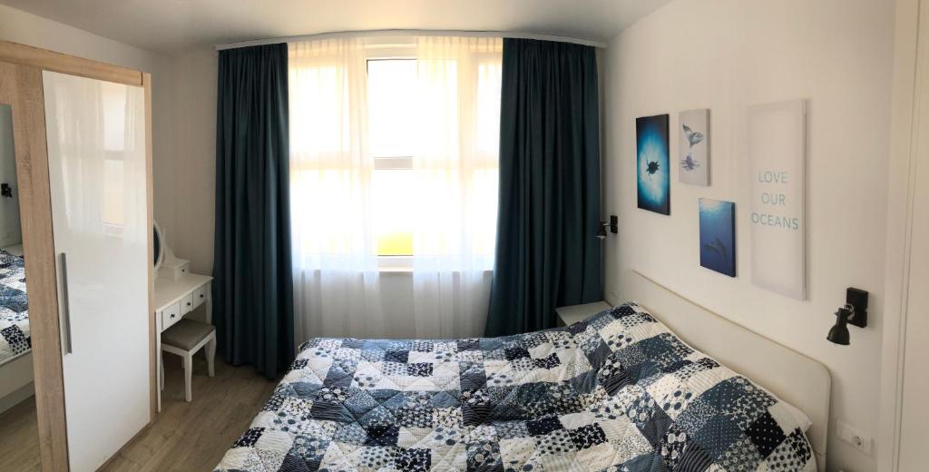 a bedroom with a bed and a window at Pula Center Seaview Apartment in Pula