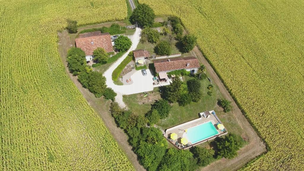 an aerial view of a house in a field at La Tranquillite, La Serenite in Nanteuil-de-Bourzac