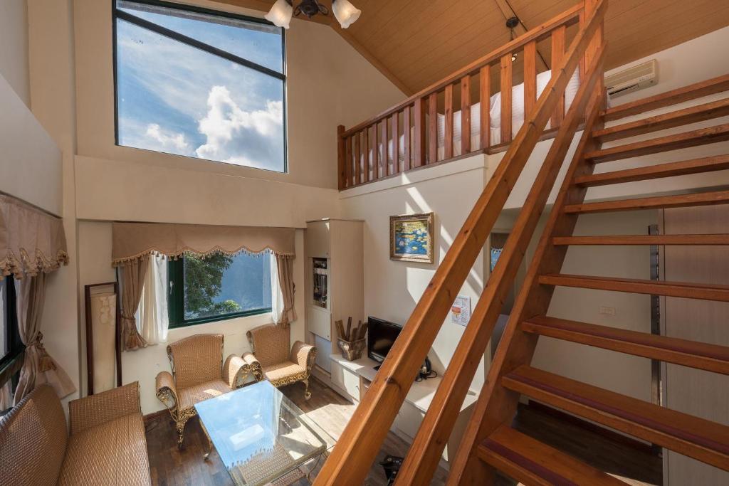 an overhead view of a living room with a spiral staircase at Emmanuel Farm House in Ren&#39;ai