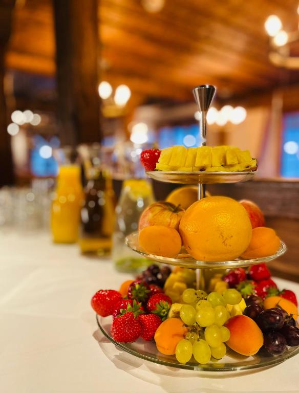 a three tiered plate of fruit on a table at Hotel Steinbock in Klosters