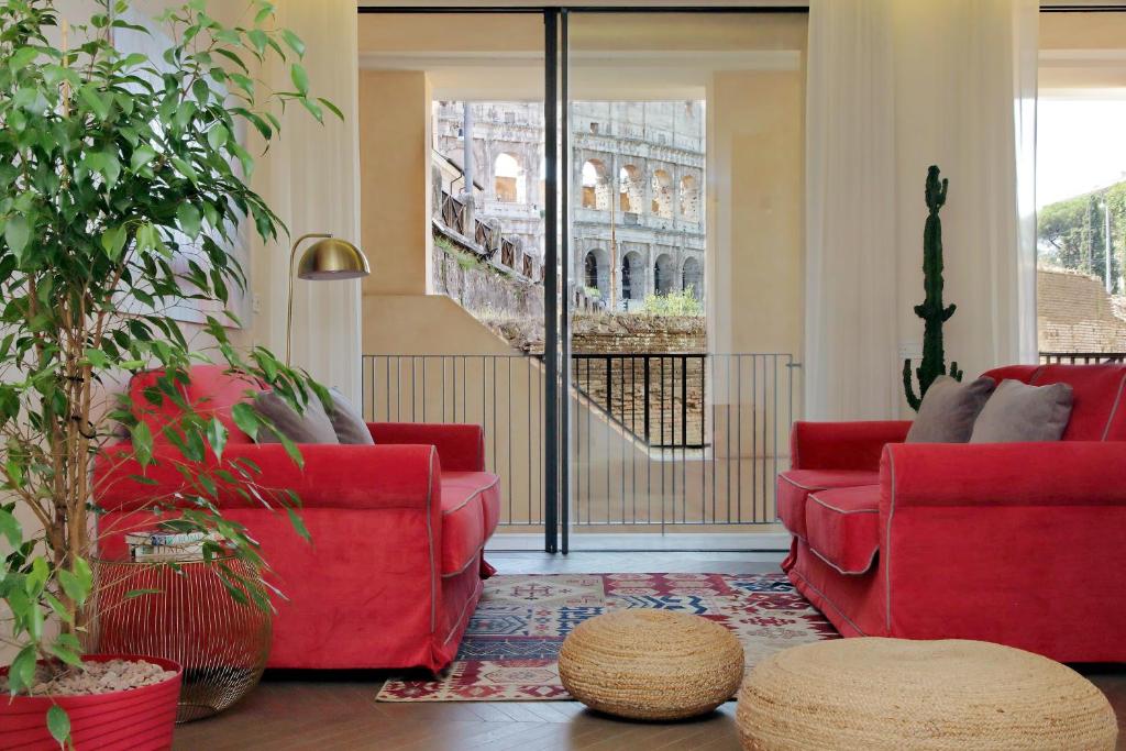 a living room with red furniture and a view of the louvre at Luxury Domus Apartment 2 in Rome