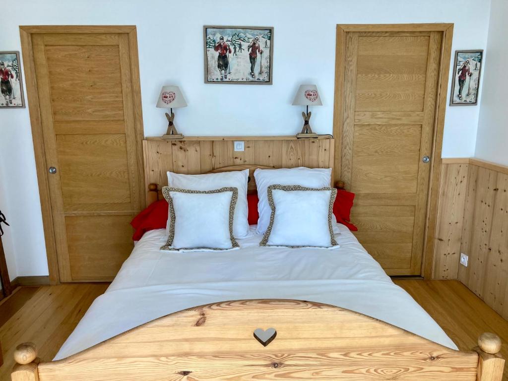 a bedroom with a large wooden bed with white sheets at Chambre Belledonne in La Tronche