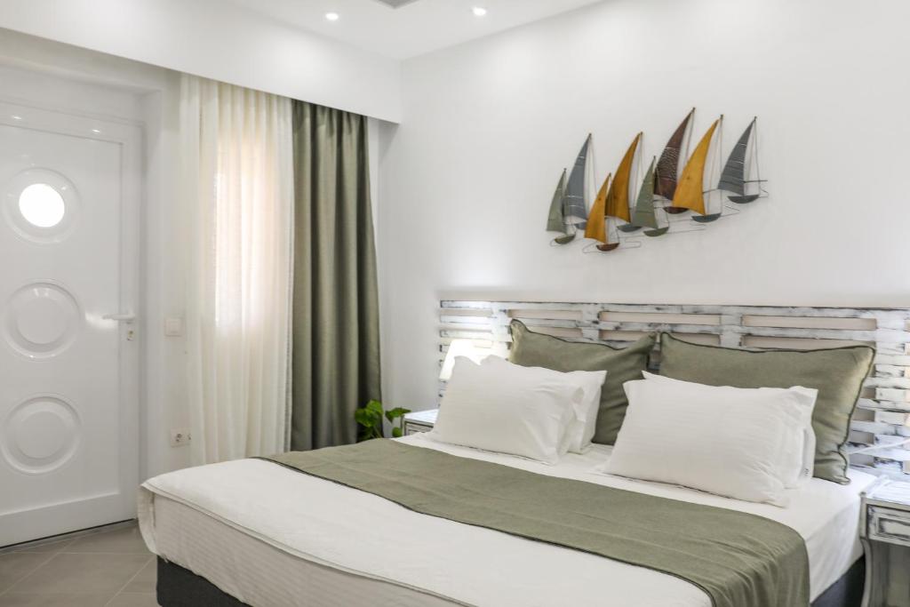 a bedroom with a bed with surfboards on the wall at Aura Skiathos in Skiathos
