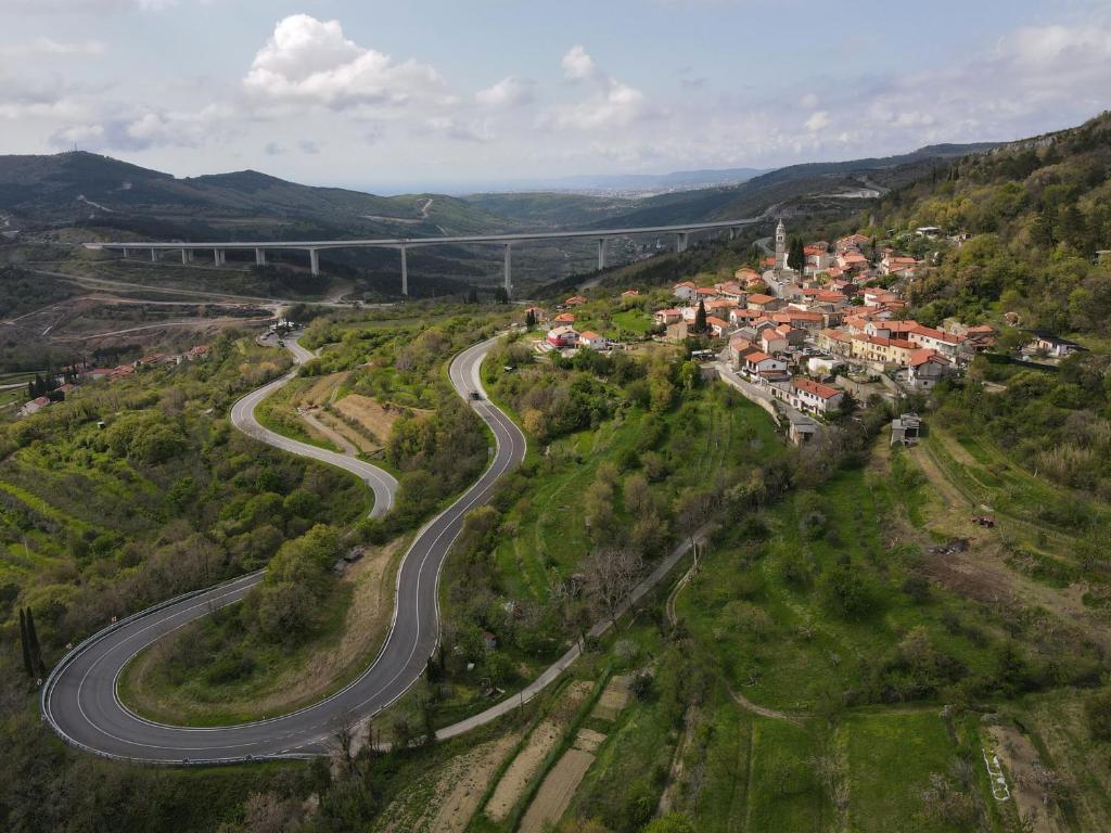 an aerial view of a winding road in a village at Apartment Beautiful Črni Kal in Črni Kal