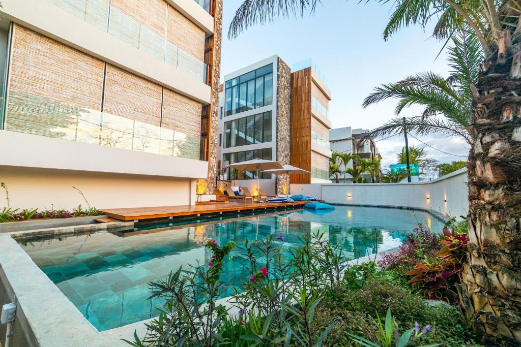 an image of a swimming pool in front of a building at One Bay Residence Modern Contemporary Apartment Flat 4 in Grand Baie