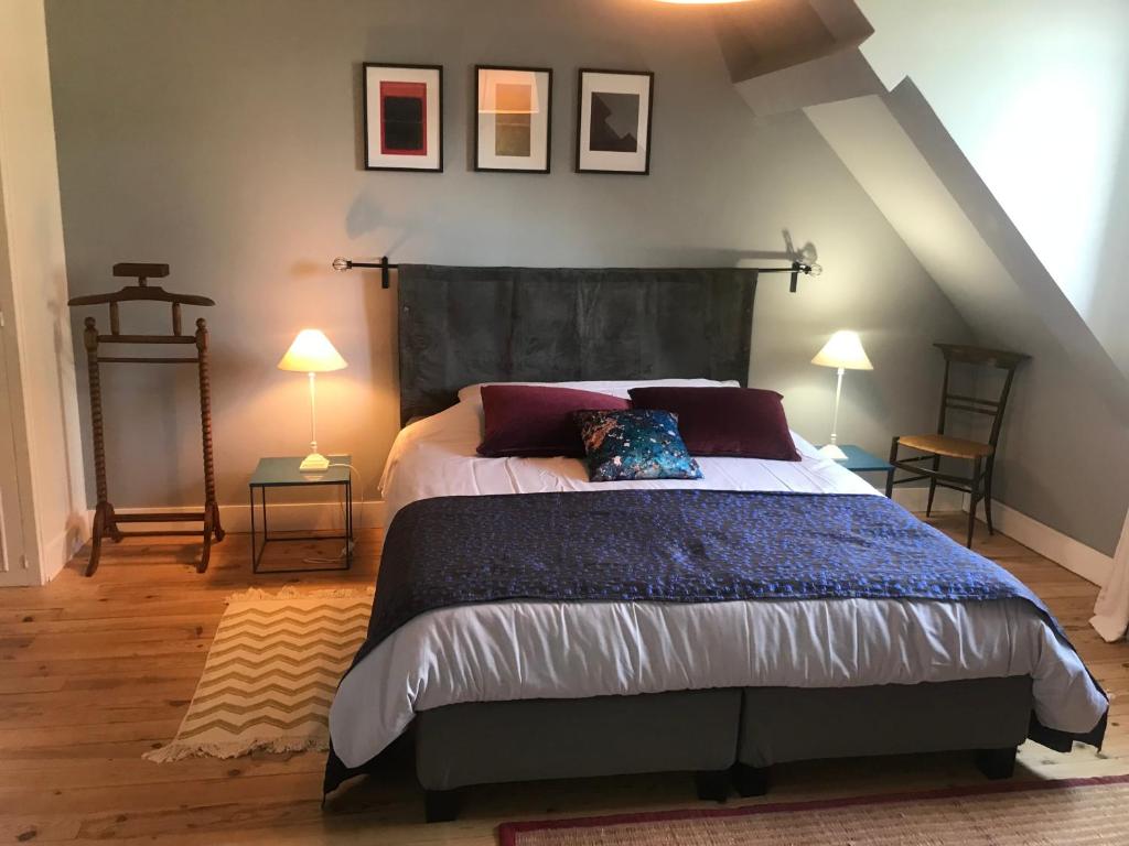 a bedroom with a large bed in a attic at Les chambres de Marie in Tours