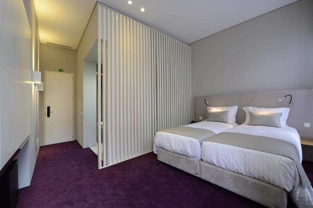 Postel nebo postele na pokoji v ubytování EMAJ Boutique Hotel